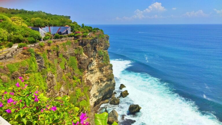 Uluwatu Temple is located on the edge of a cliff bordering the ocean.